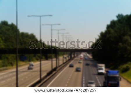 BEACONSFIELD, ENGLAND - JUNE 2016: Busy M40 motorway at the Beaconsfield turn off  Out of focus.