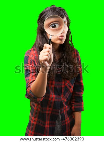 latin girl looking through a magnifying glass