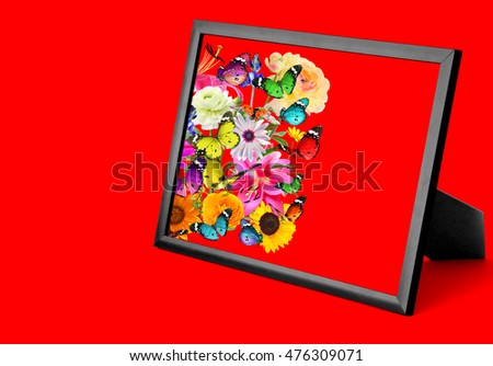 Nature art composition on red. Colorful flowers, butterflies and ladybug. Wooden frame with blank space (for photo,picture or text)