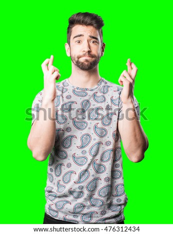 young man crossing finger