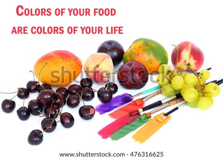 Colorful healthy raw fresh fruit and various paints with brushes on a white background. Variety of food and art color. Colors of your food are colors of your life (or space for your text there)