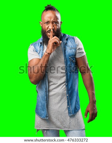 black man doing a silence sign