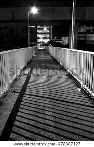 shadow of the grille of the overpass with lamp in black and white