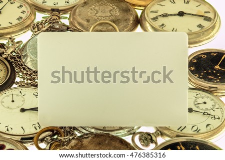 Blank card on a background of vintage pocket watch collection.