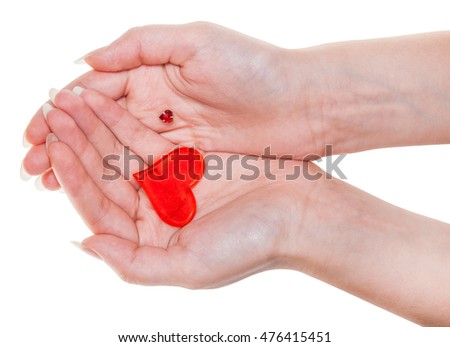 two red hearts on female palms isolated on white background