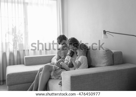Black and white portrait. Young, happy couple and their two children