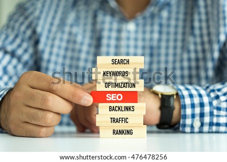 Businessman Building SEO concept with Wooden Blocks Royalty-Free Stock Photo #476478256