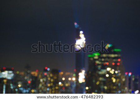 Blurred bokeh light panoramic picture of Bangkok city, night light show over CBD area
