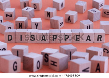 DISAPPEAR word on wooden cube isolated on orange background