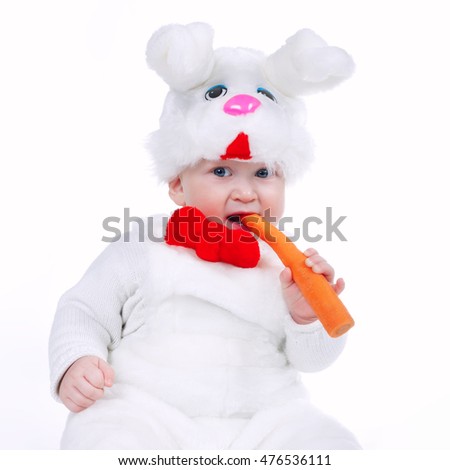 little boy in rabbit costume with carrot isolated