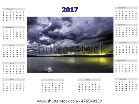 Calendar for 2017 with storm clouds over the lake in various colors with mystical appearance