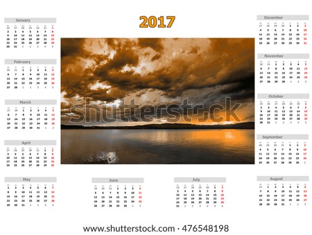 Calendar for 2017 with storm clouds over the lake in various colors with mystical appearance