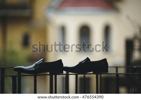 Two black groom's shoes on the balcony