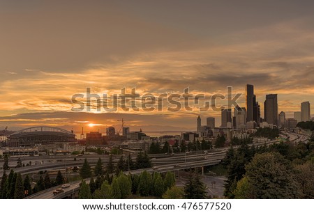 Seattle bathed in golden light from the sunset over the Olympic Mountains