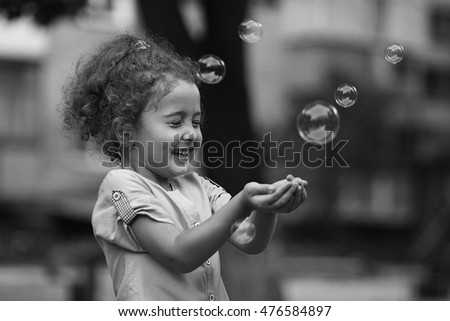 child , soap bubbles Royalty-Free Stock Photo #476584897