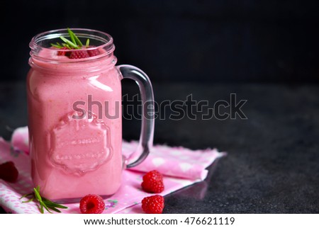 Summer cool drink, a smoothie with raspberry and peach on a black background