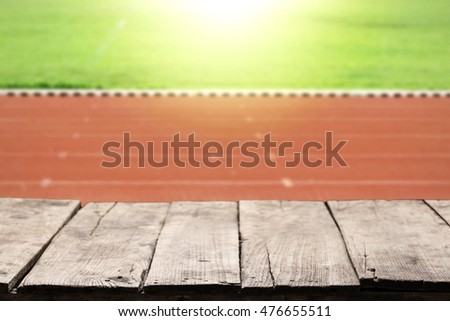 Empty old wood table with blurry running track background for use as product display or montage your job.