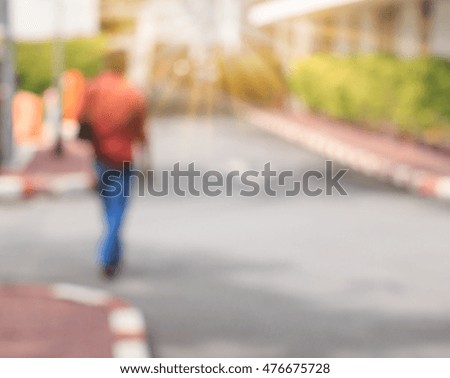 One street with people walking past , Making light soft and blur.