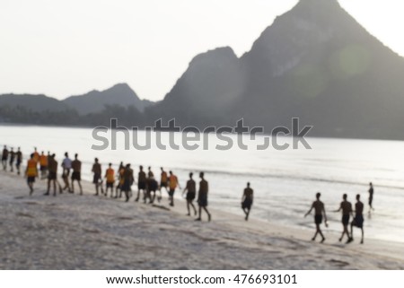 Soldiers are helping to clean the sand by the sea.Blur image
