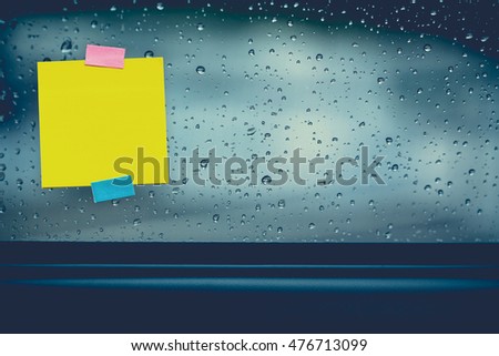 Vintage picture tone of drops rain on car window with sticker note for add text message.