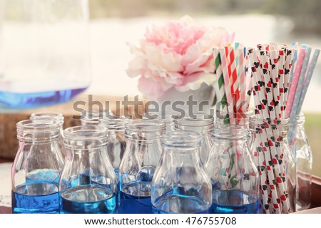 blue drink bottles with paper straws, Alice in wonderland tea party theme,toning