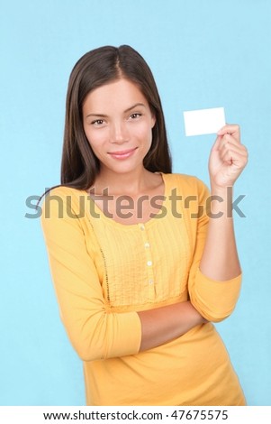 Sign woman showing a blank business card on blue background.