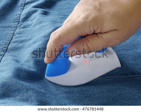 Ironing blue jean jacket, Housework
