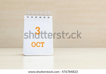 Closeup surface note book with orange 3 oct word  in page on blurred brown wood desk and wood wall textured background with copy space under window light