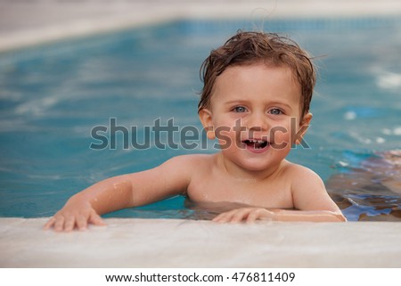 Funny baby cooling off in the pool