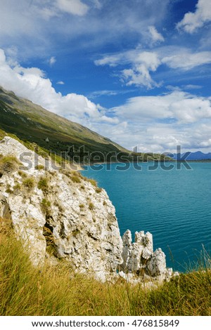 White rocks and clouds over lake in French Alps. Vanoise National Park. (Savoie, France)