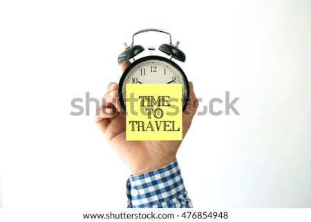 Hand Holding Alarm Clock and Pointing TIME TO TRAVEL