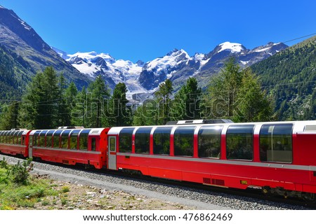 Swiss mountain train Bernina Express crossed Alps with glaciers in the backgroundin the summer Royalty-Free Stock Photo #476862469