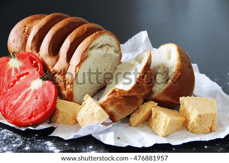 bread and cheese and tomatoes on table