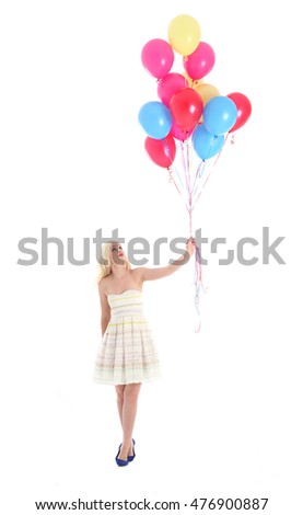 Full length portrait of a pretty blonde girl wearing a white dress, holding a bunch of colourful balloons. Isolated on what background.