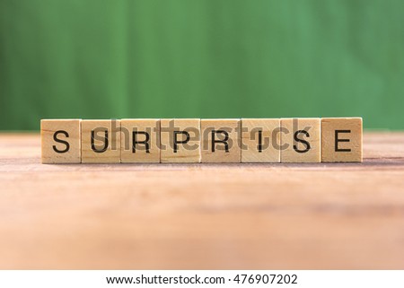 the word of SURPRISE on wood tiles concept