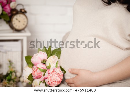 Waiting for baby, mammy's belly. Pregnant woman hugging her belly with hands