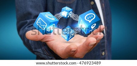 Young businessman connecting modern cube interface in his hand 3D rendering
