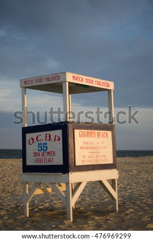 A lifeguard tower stands empty on a sunny beach
