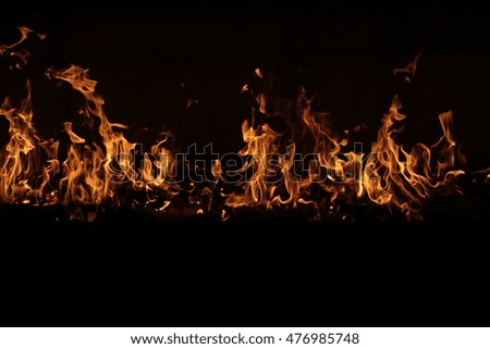 Abstract burning flame. Orange fire line on black background.