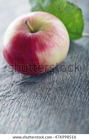 Red apple on wooden background with vintage editing