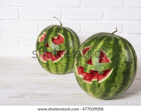 Smiling face of watermelon on a Halloween like a pumpkin for Halloween