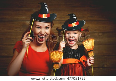 Family fun mother and child daughter having fun and celebrate Halloween in witch costume