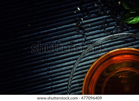 Tea with herbs, black background, top view