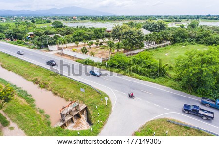 Top view of rural road with village and tree