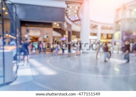 Blurred image of people in shopping mall with bokeh background concept