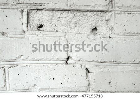 A texture of aged brick wall covered with weathered plaster