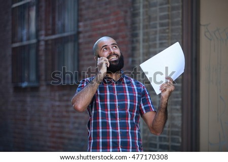 Bald bearded, successful businessman, urban consultant, advisor, talking with phone, documents on hand