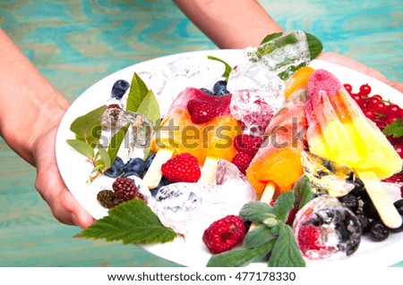 Hands serving delicious ice cream and fruits with ice cubes