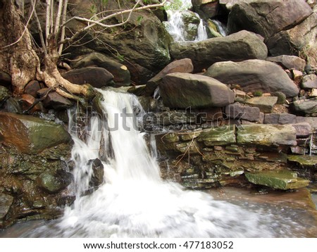 waterfall and jungle creek emerging through rocks, tropical India