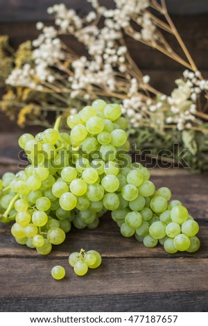 Sultan Grapes on a wooden background. Close-up. Selective focus
